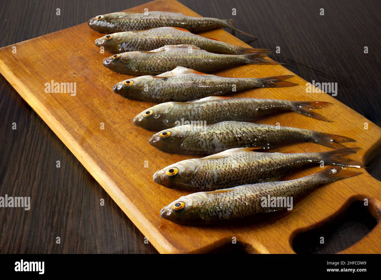 Peeled fish on the board. Fish for cooking. Stock Photo