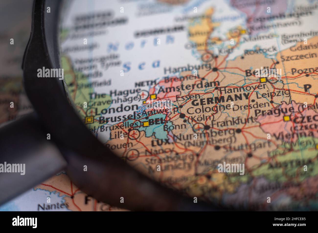 Germany on a world map through magnifying glass. Germany travel destination planning pinned Stock Photo