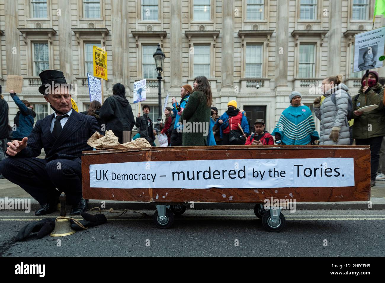 London, UK.  15 January 2022.  A costumed undertaker with a mocked up coffin outside Downing Street during a Kill the Bill protest in central London.  The protests were prompted by the Police, Crime, Sentencing and Courts Bill, which propose to give police in England and Wales more power to impose conditions on non-violent protests, including those which are deemed too noisy or a nuisance. Credit: Stephen Chung / Alamy Live News Stock Photo