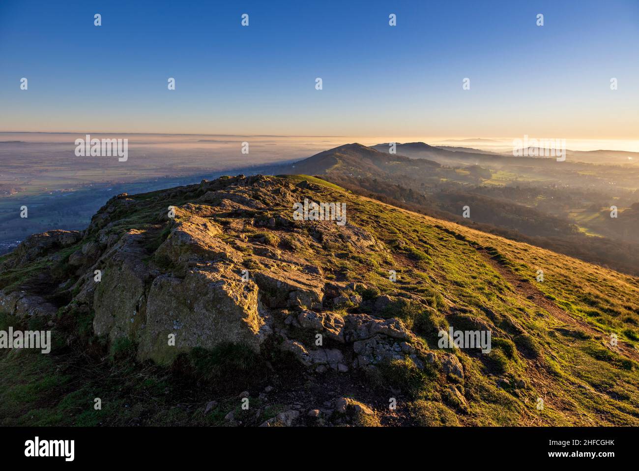 Sunlit granite rocks at Worcestershire Beacon on a winter's afternoon in the Malverns, England Stock Photo