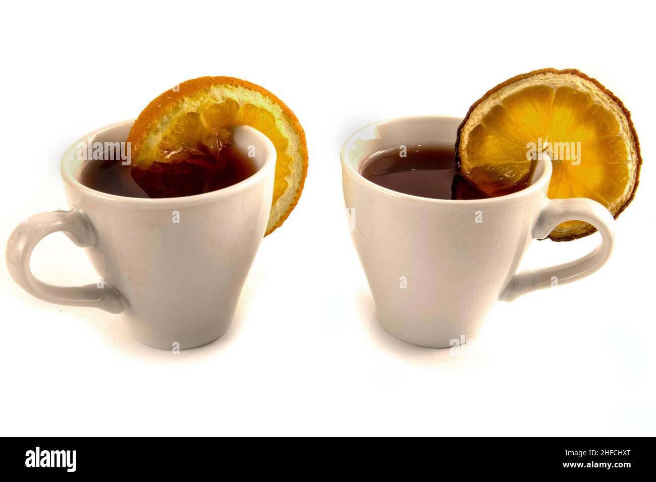 White mug with tea and dried oranges isolated on white Stock Photo