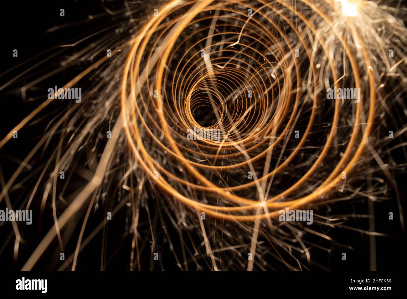 Circular lights with sparks on a black background Stock Photo