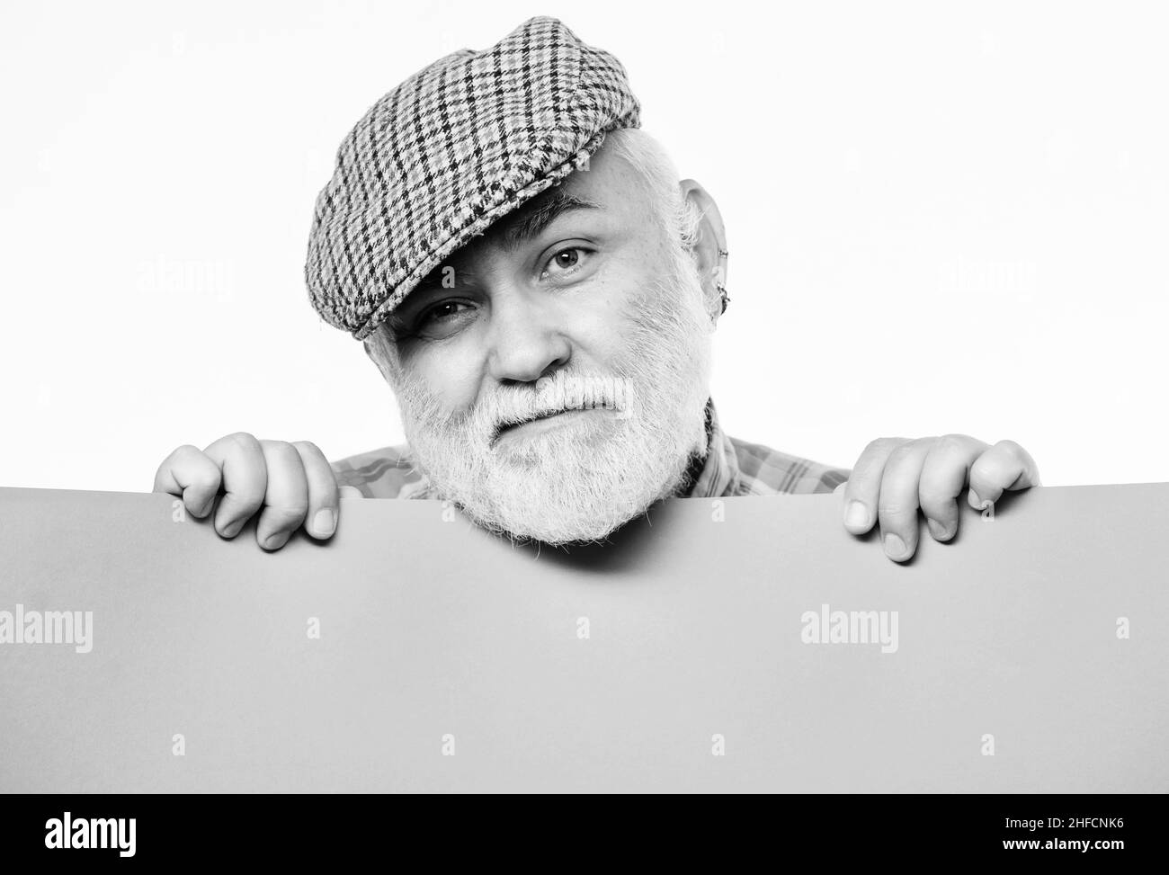 Weekend entertainment. Senior bearded man peeking out of banner place information. Public information. Advertisement elderly people. Announcement Stock Photo