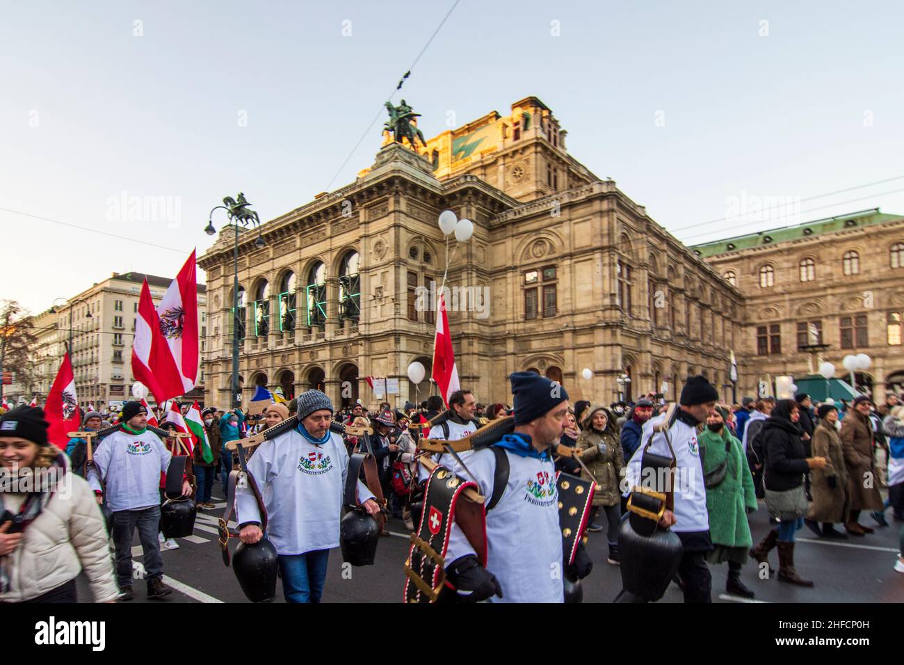 Wien, Vienna: men with cow bells from Vorarlberg, Corona protest demonstration in front of opera Staatsoper, opponents of the corona measures march, m Stock Photo