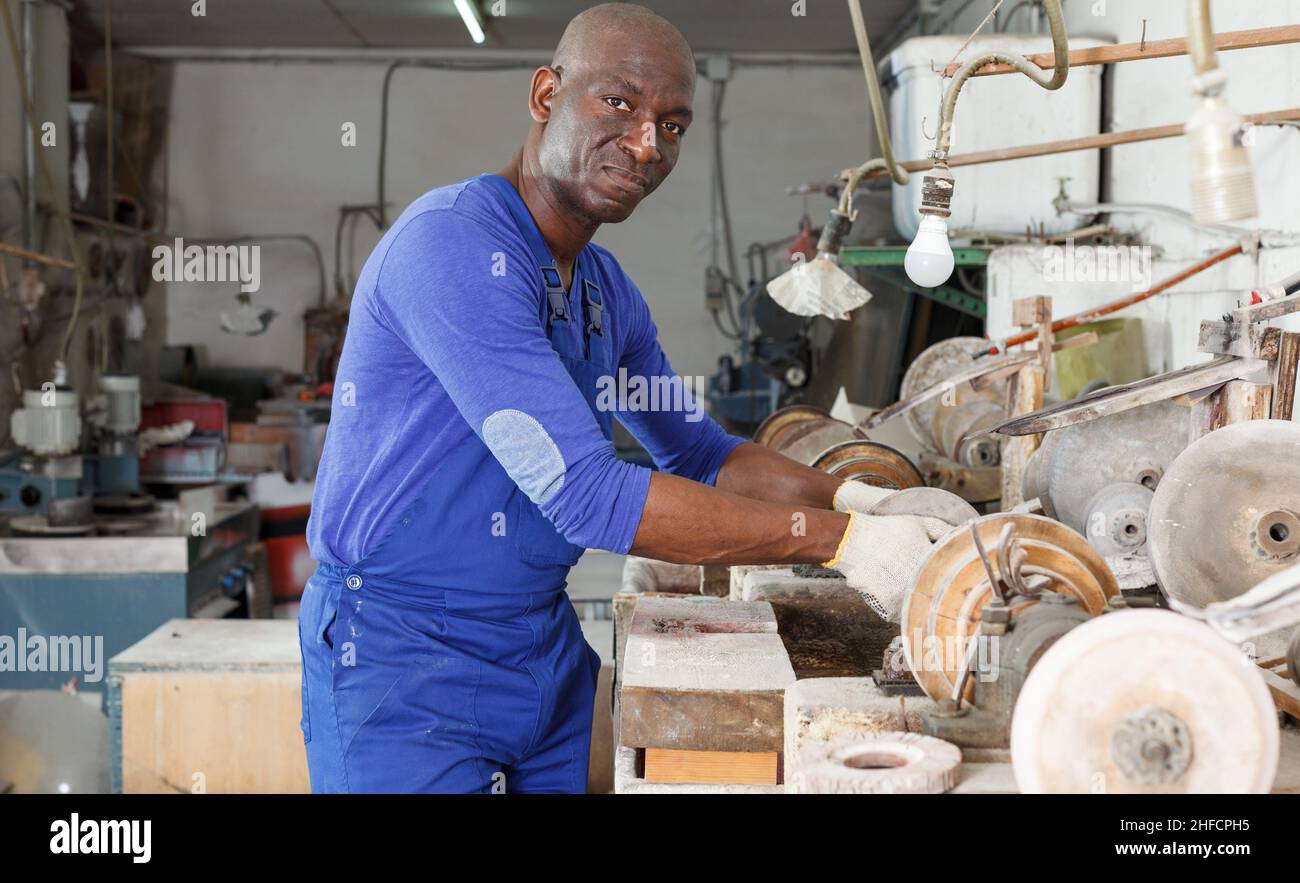 Workman checking glass processing machine Stock Photo - Alamy
