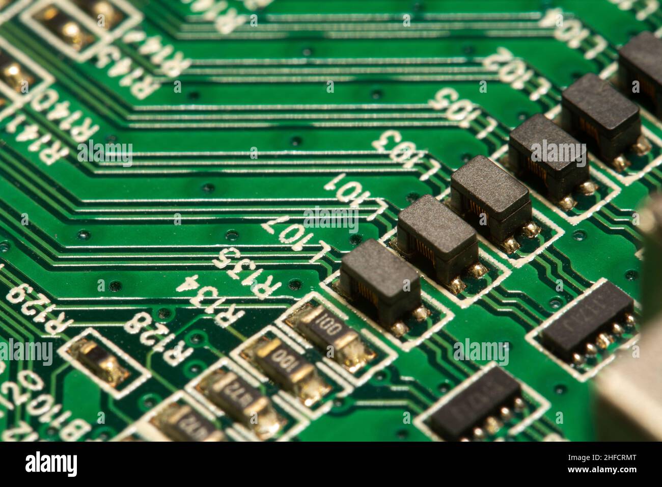 SMD components soldered on a green printed circuit board (PCB). Stock Photo