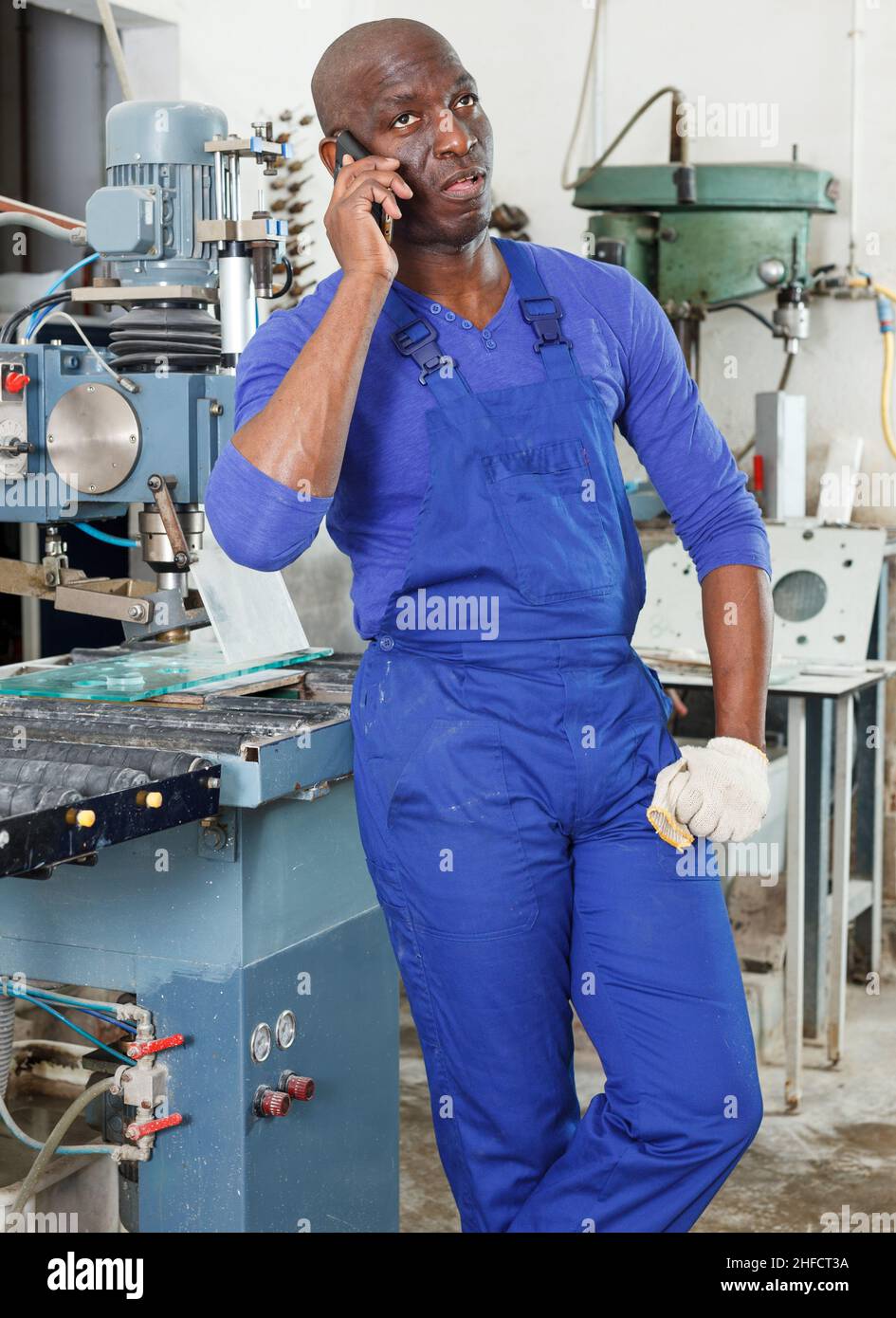 Worker talking on phone Stock Photo