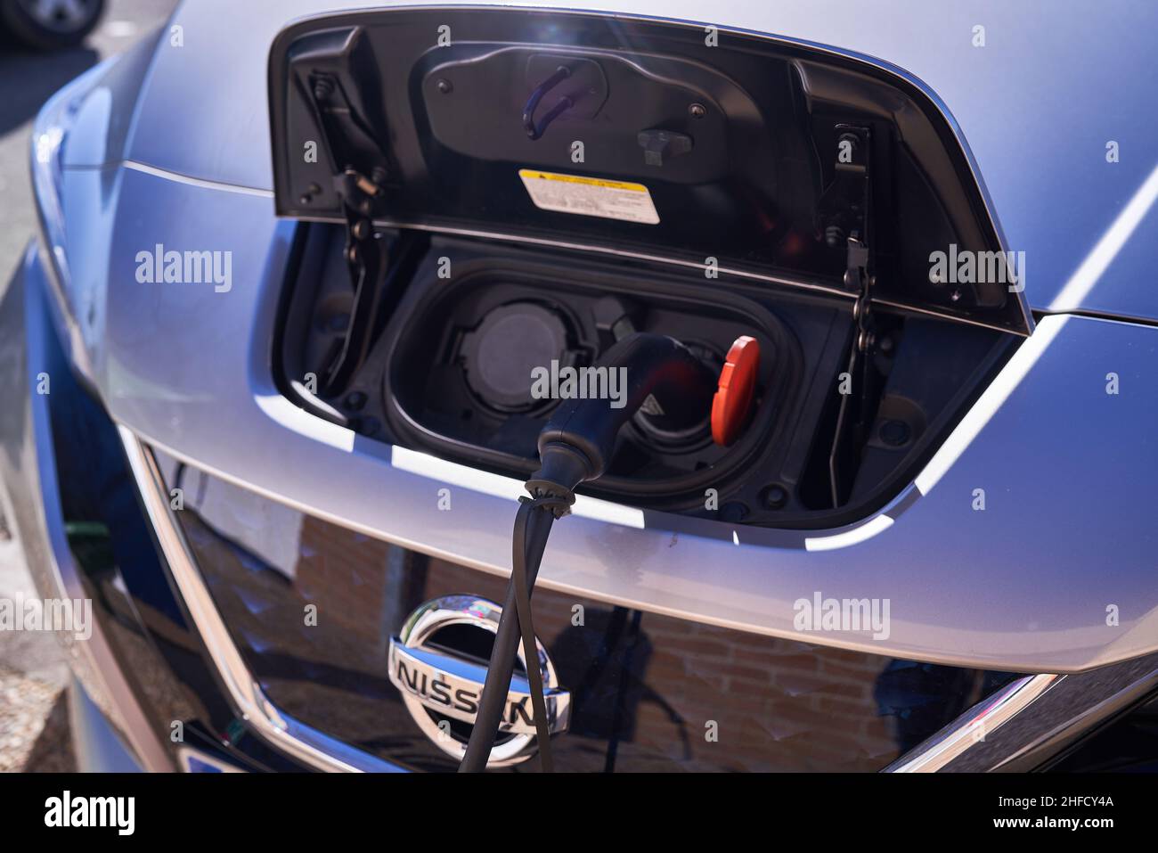 PAMPLONA, NAVARRA SPAIN JANUARY 13 2022: Electric car charging next to charging station Stock Photo