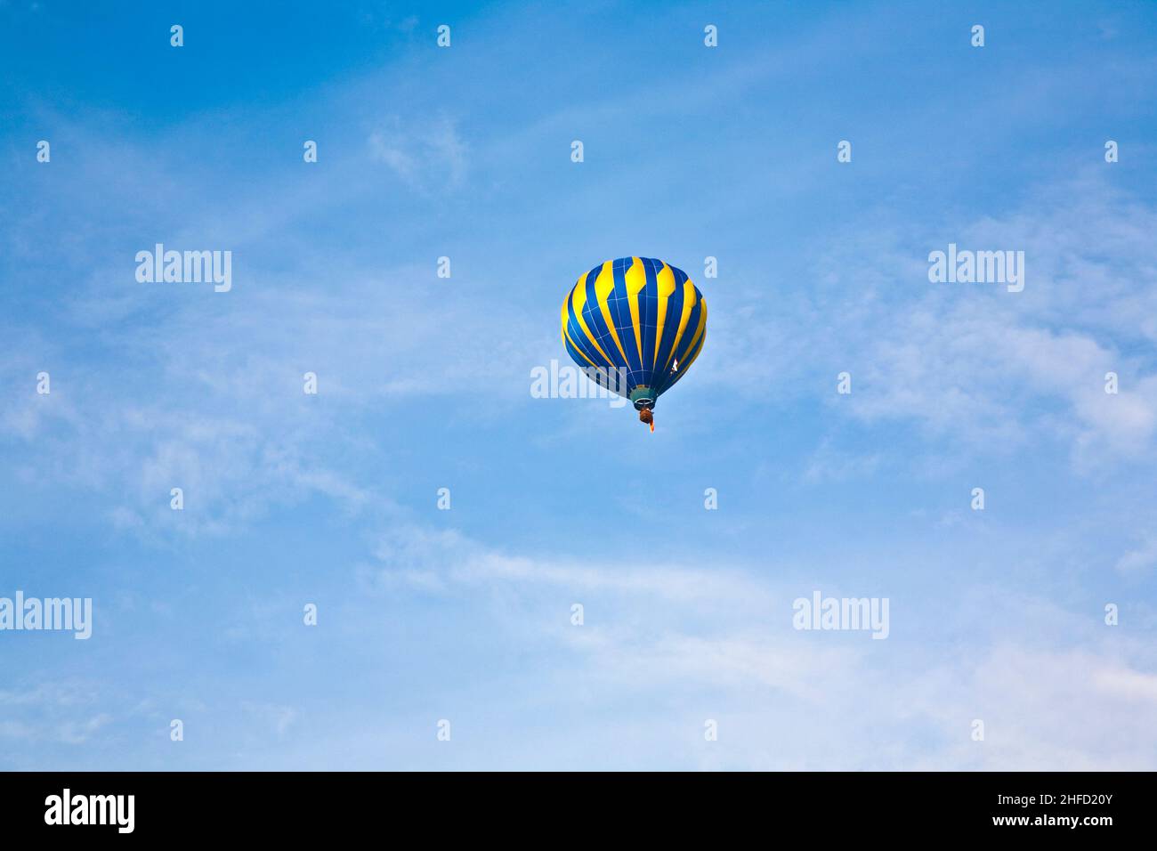 Hot Air Balloon in cloudy sky Stock Photo - Alamy