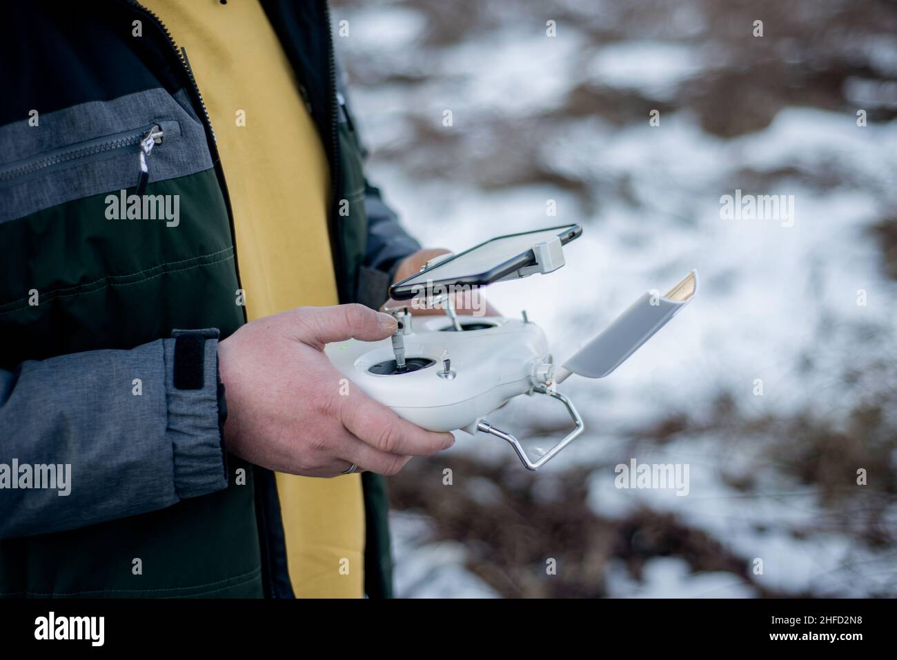 drone operator outdoors in snow Stock Photo