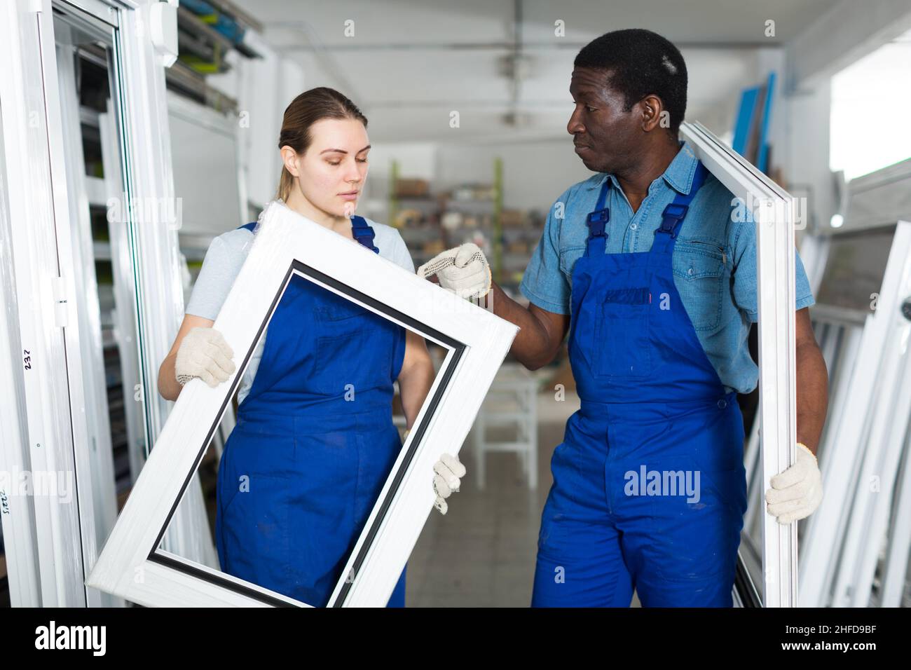 Two masters are conflicting in time working with window frame Stock Photo