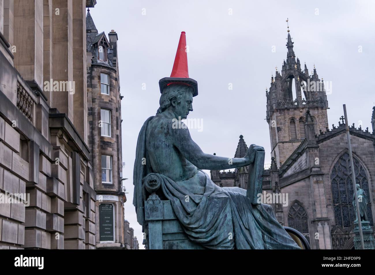 The statue of Scottish philosopher David Hume on Edinburgh's Royal Mile, with a red traffic cone on its head Stock Photo