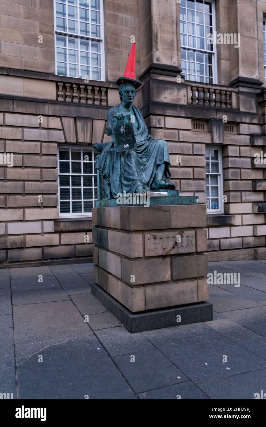 The statue of Scottish philosopher David Hume on Edinburgh's Royal Mile, with a red traffic cone on its head Stock Photo