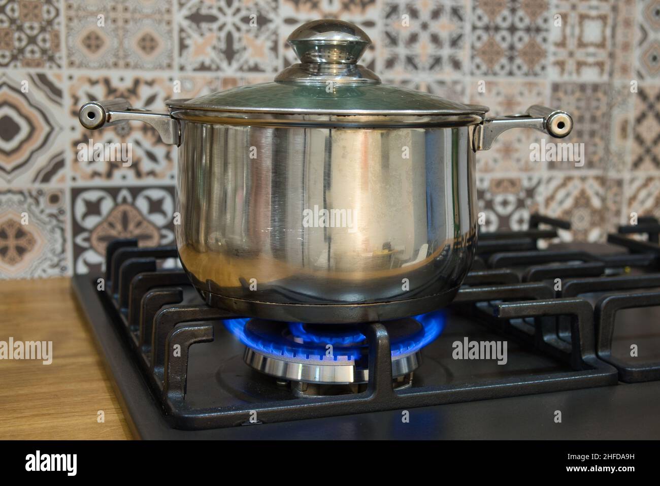 Cooking on a gas stove. The pot on gas burner. Home cooking concept