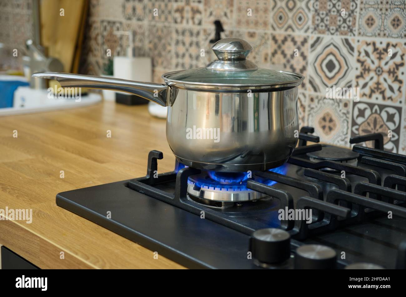 Cooking on a gas stove. The pot on gas burner. Home cooking concept