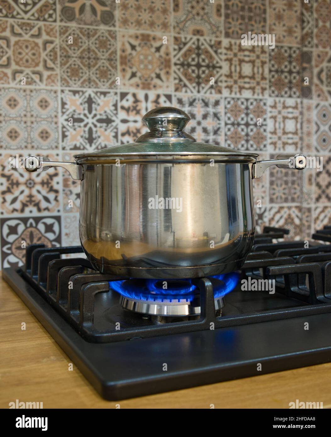 Cooking on a gas stove. The pot on gas burner. Home cooking concept