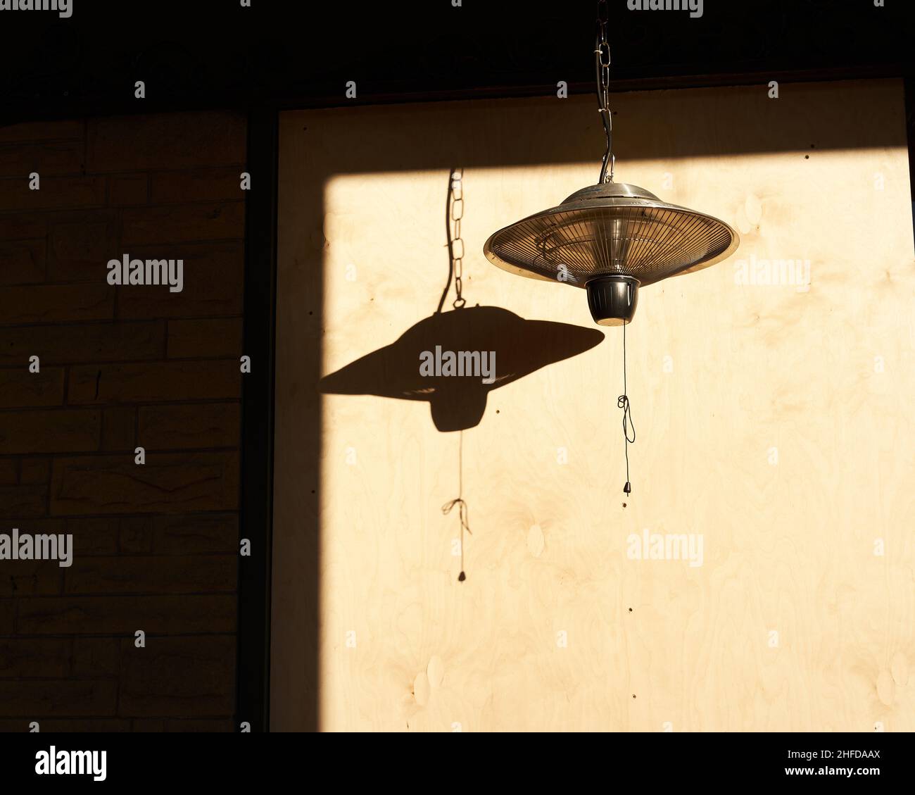 Brass pendant lamp casting shadow on awall Stock Photo Alamy