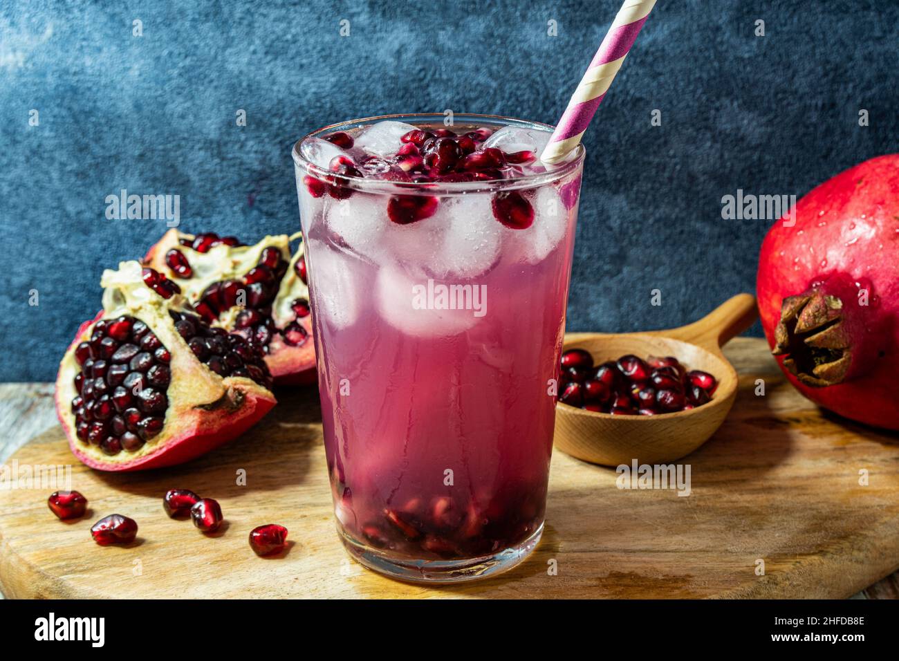 Healthy pomegranate juice, served with ice and straw Stock Photo
