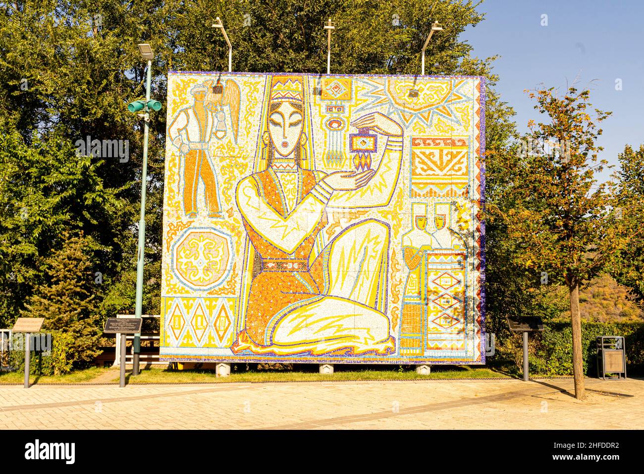 'The Girl with the Souvenir'; 'Sulushash' Tiled mosaic panno installed in Kok Tobe tourist park, depicting Kazakh woman, Almaty. 1970, reinstalled Stock Photo