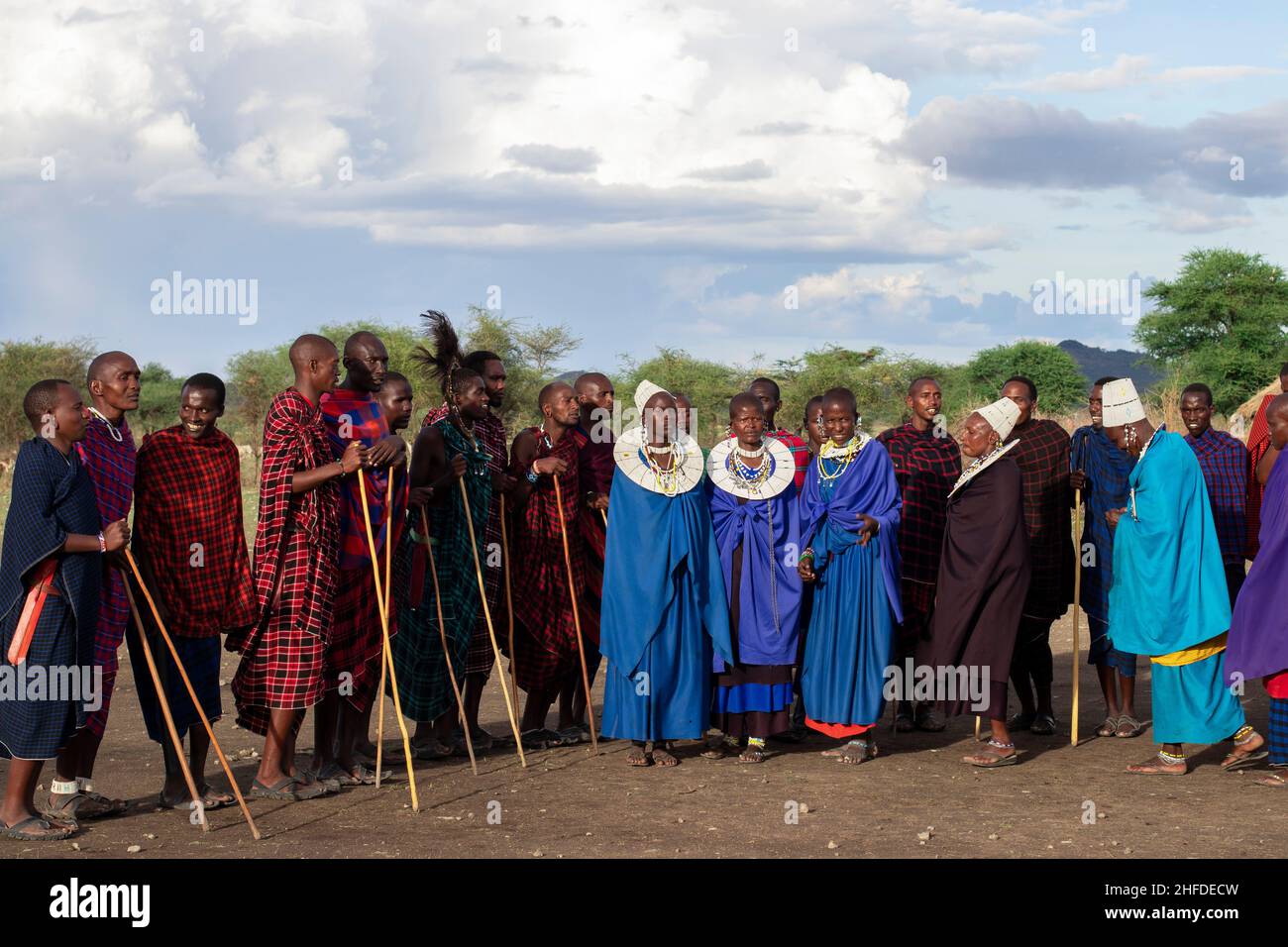 Men and women of Masai Tribe dancing and singing outdoors in traditional attire 12 16 2021 Arusha Tanzania Stock Photo