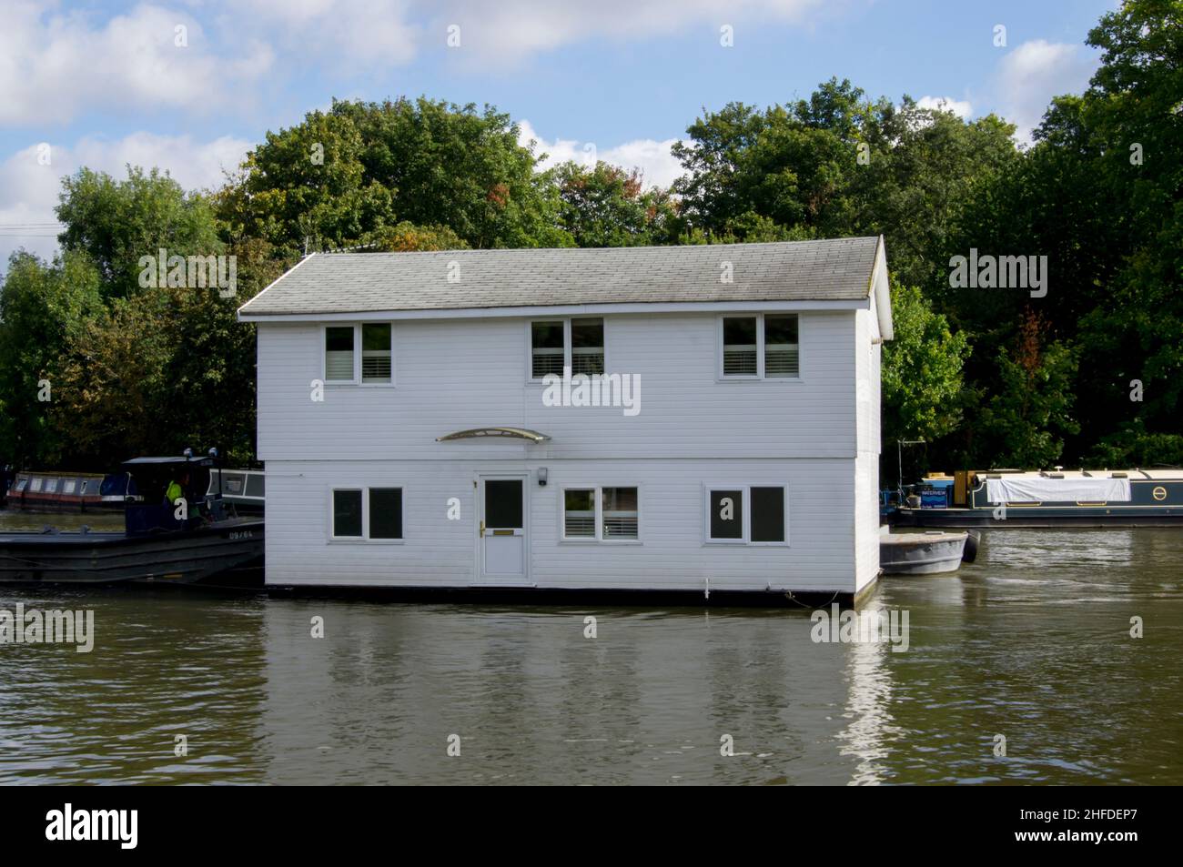 Houseboat is towed on River Thames Stock Photo