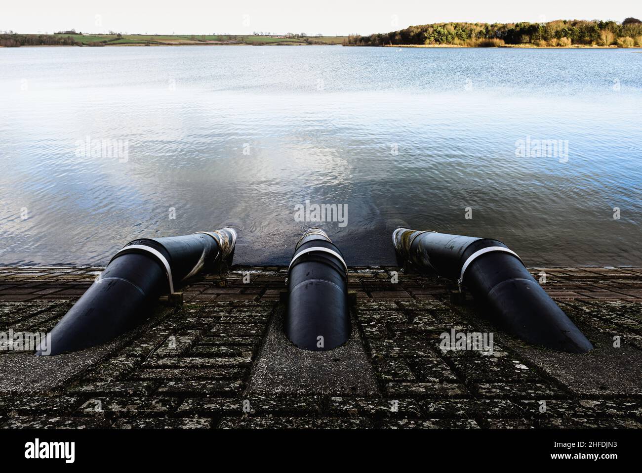 Water drainage pipes taking stored rain water to filtration site Stock Photo