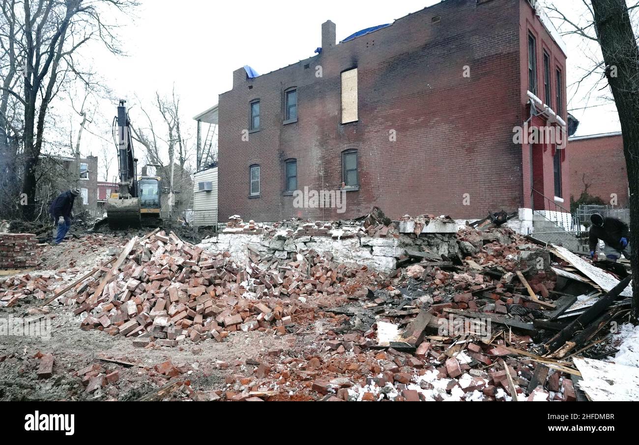 St. Louis, United States. 15th Jan, 2022. Workers stack bricks of what once was a vacant building in St. Louis on Saturday, January 15, 2022. On January 13, 2022, the building collapsed during a fire, killing one St. Louis firefighter and injuring several others. St. Louis reportedly has nearly 10 thousand vacant buildings becoming a hazard for firefighters, being a place to sleep for the many homeless of the area. Photo by Bill Greenblatt/UPI Credit: UPI/Alamy Live News Stock Photo