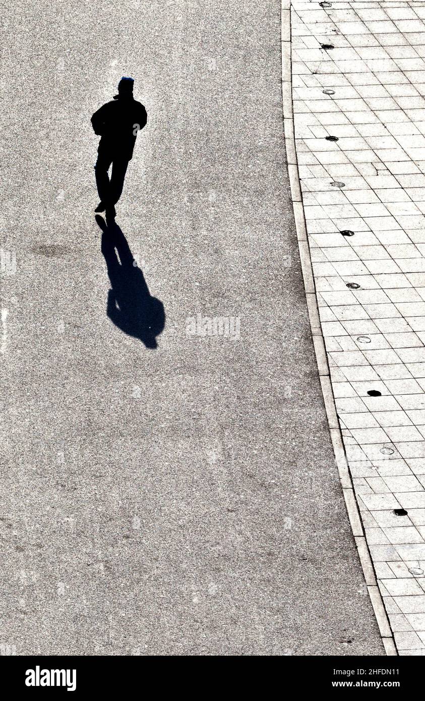 people walking at the street with long shadows Stock Photo - Alamy