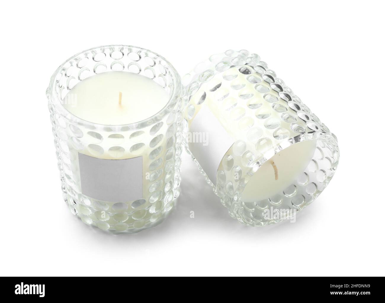 Beautiful wax candles in glass holders isolated on white background ...