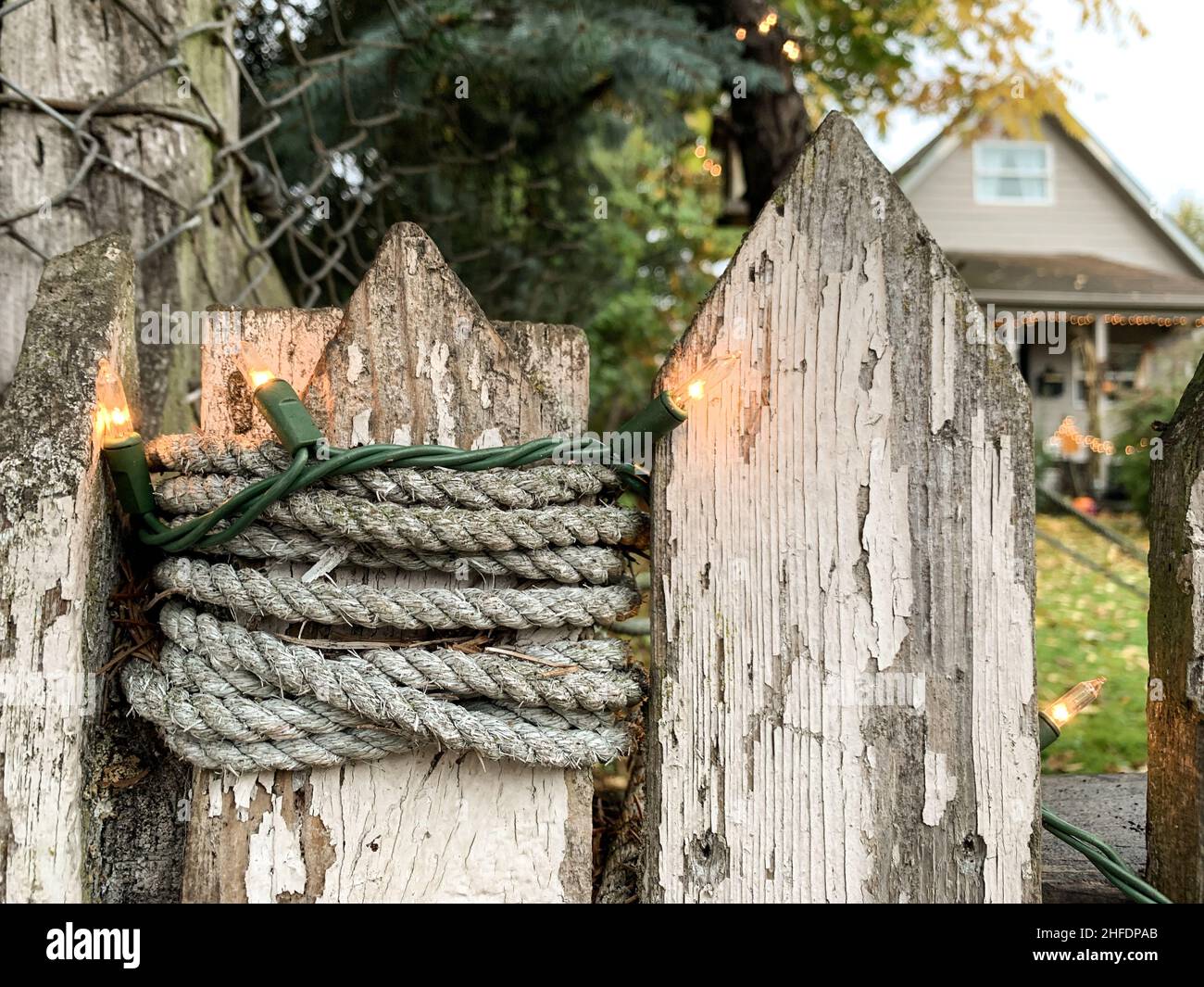 Holiday lights on an old wooden picket fence Stock Photo