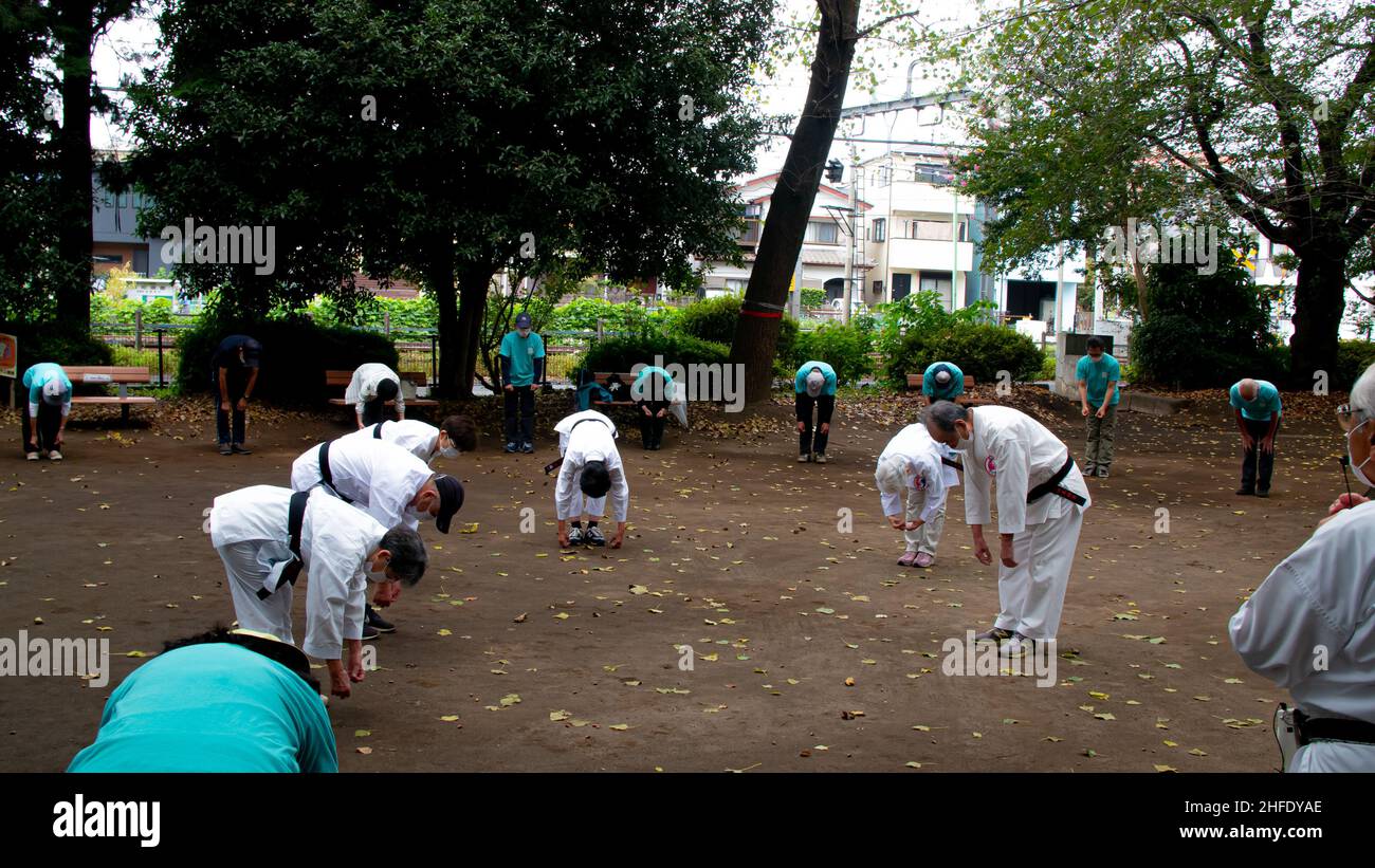 Asian elderly people practicing Tai Chi at public park Stock Photo