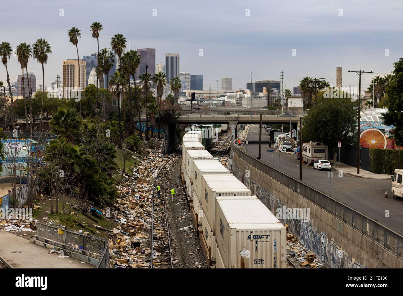 Los Angeles, USA. 15th Jan, 2022. Workers walk amongst the shredded