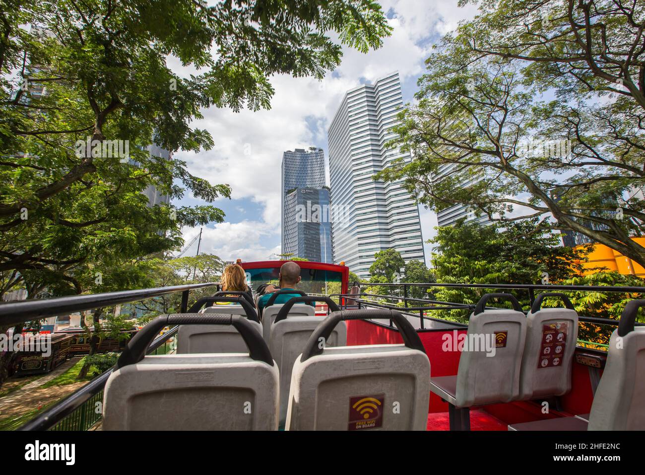 Sitting on open top bus travel through Singapore green city concept. Stock Photo