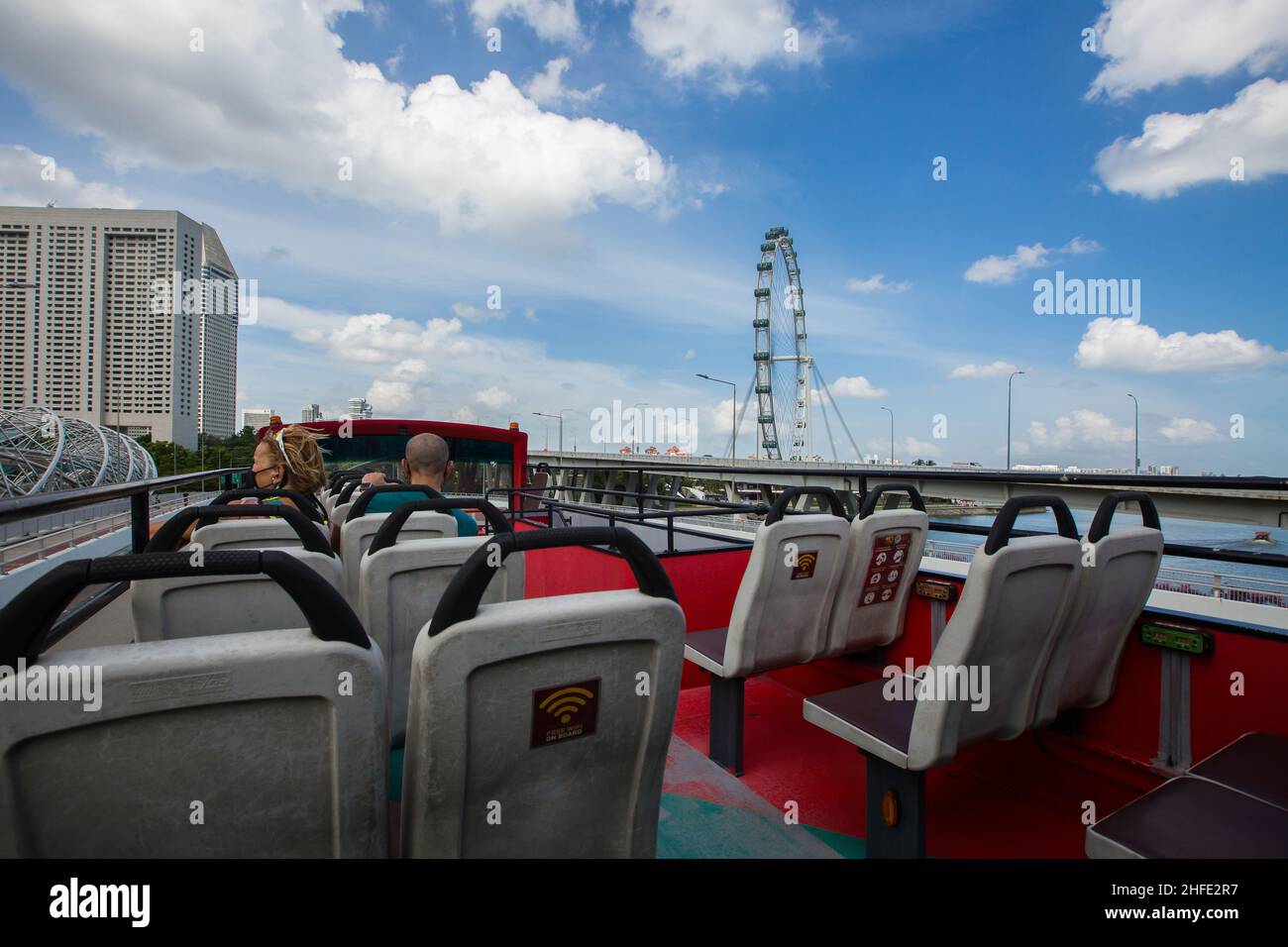 Traveling on open top double decker bus which can see the entire landscape off Singapore Flyer. Stock Photo