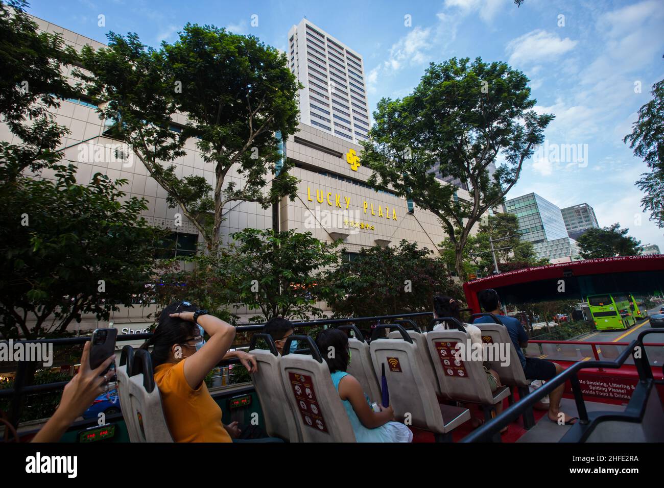 Open top bus tour bypass Lucky Plaza mall along the stretch of Orchard Road, a popular tourist shopping heaven. Singapore. Stock Photo