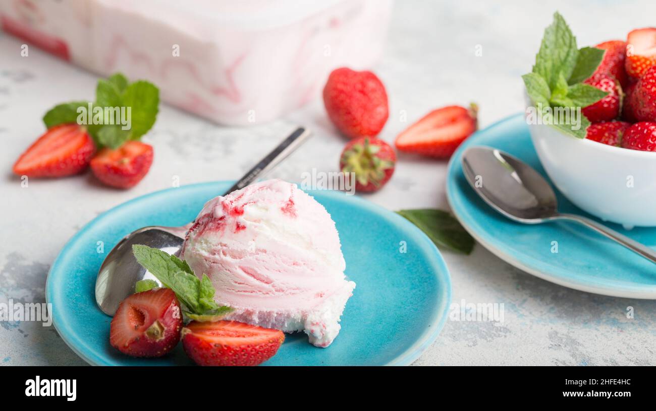 Strawberry ice cream in a waffle cone on a blue background Stock Photo ...