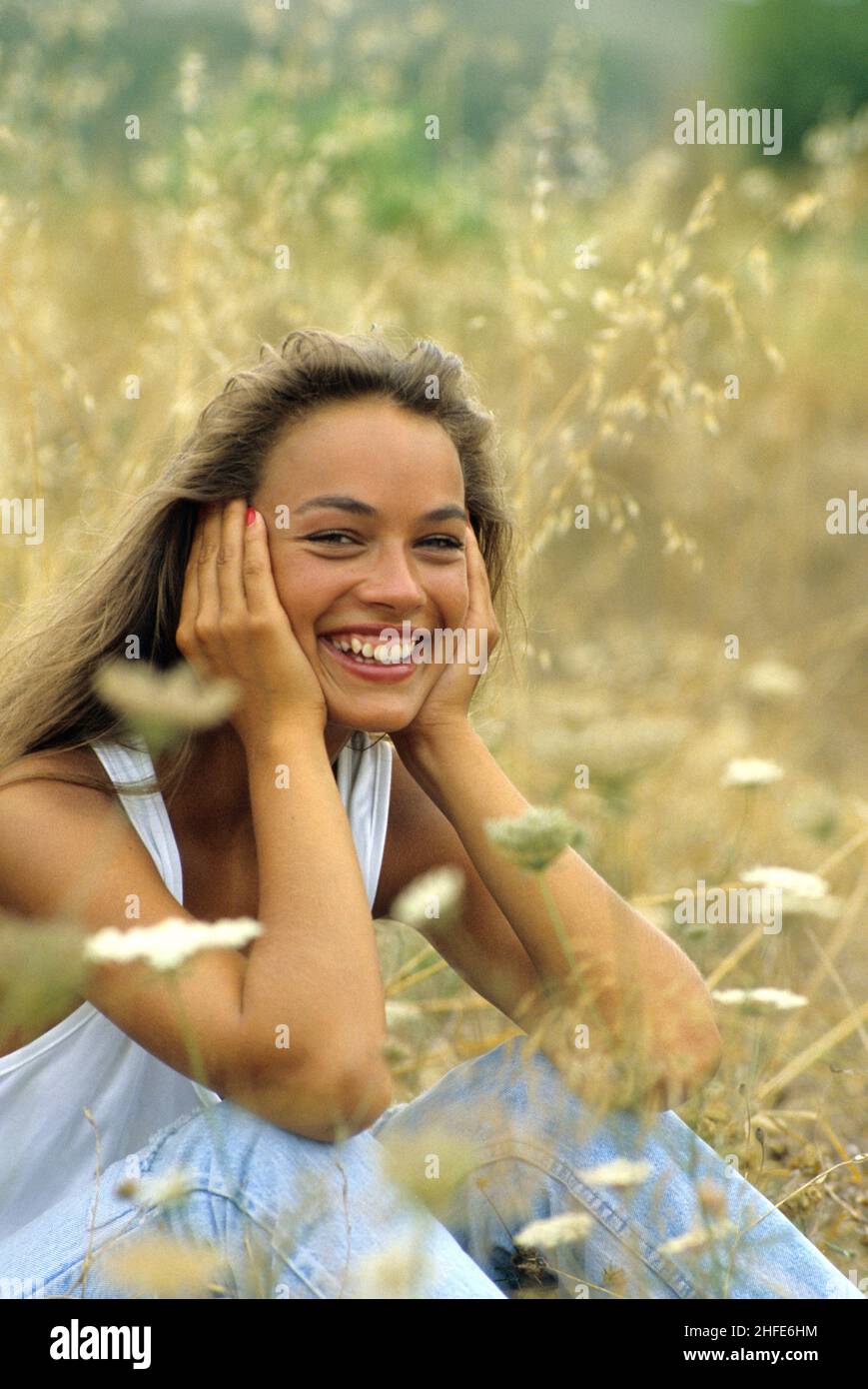 pretty brown hair young girl very expressive smiling laughing front the camera close up portrait yellow herbs background Stock Photo