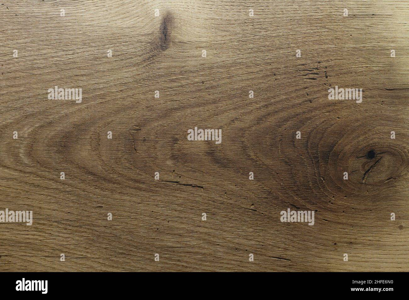 Wood texture. Wooden board close up. The cracks are deep. Laminate flooring. Tree rings in a cut