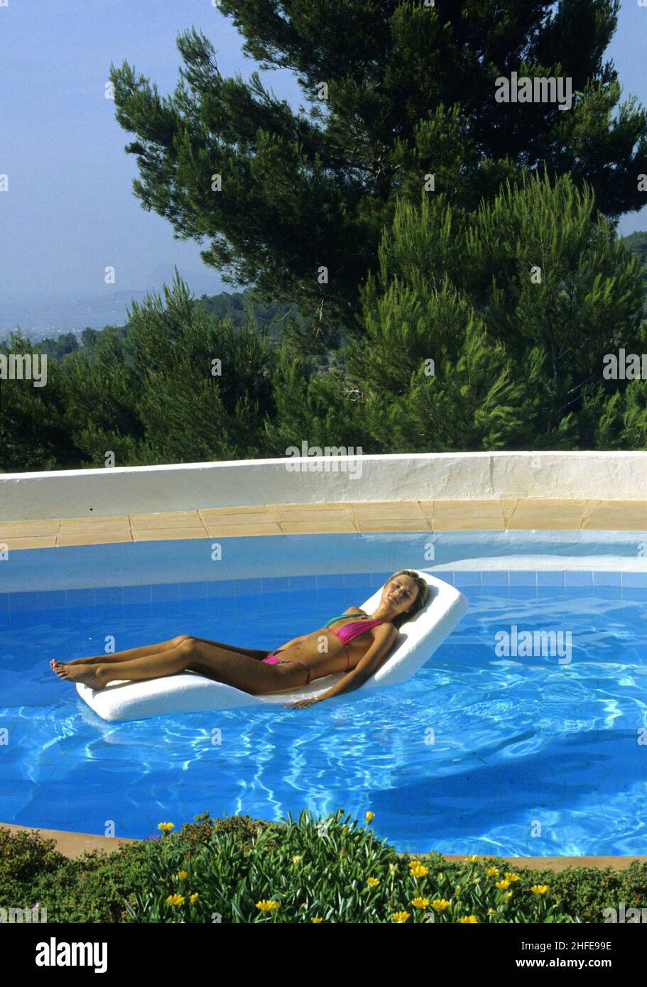 young woman swimming pool Stock Photo