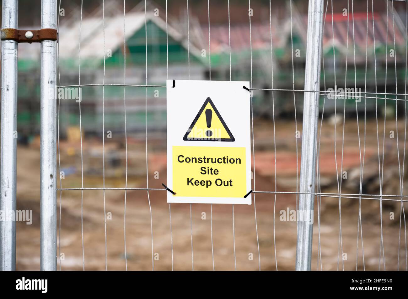 Construction site health and safety message rules sign board signage on fence boundary Stock