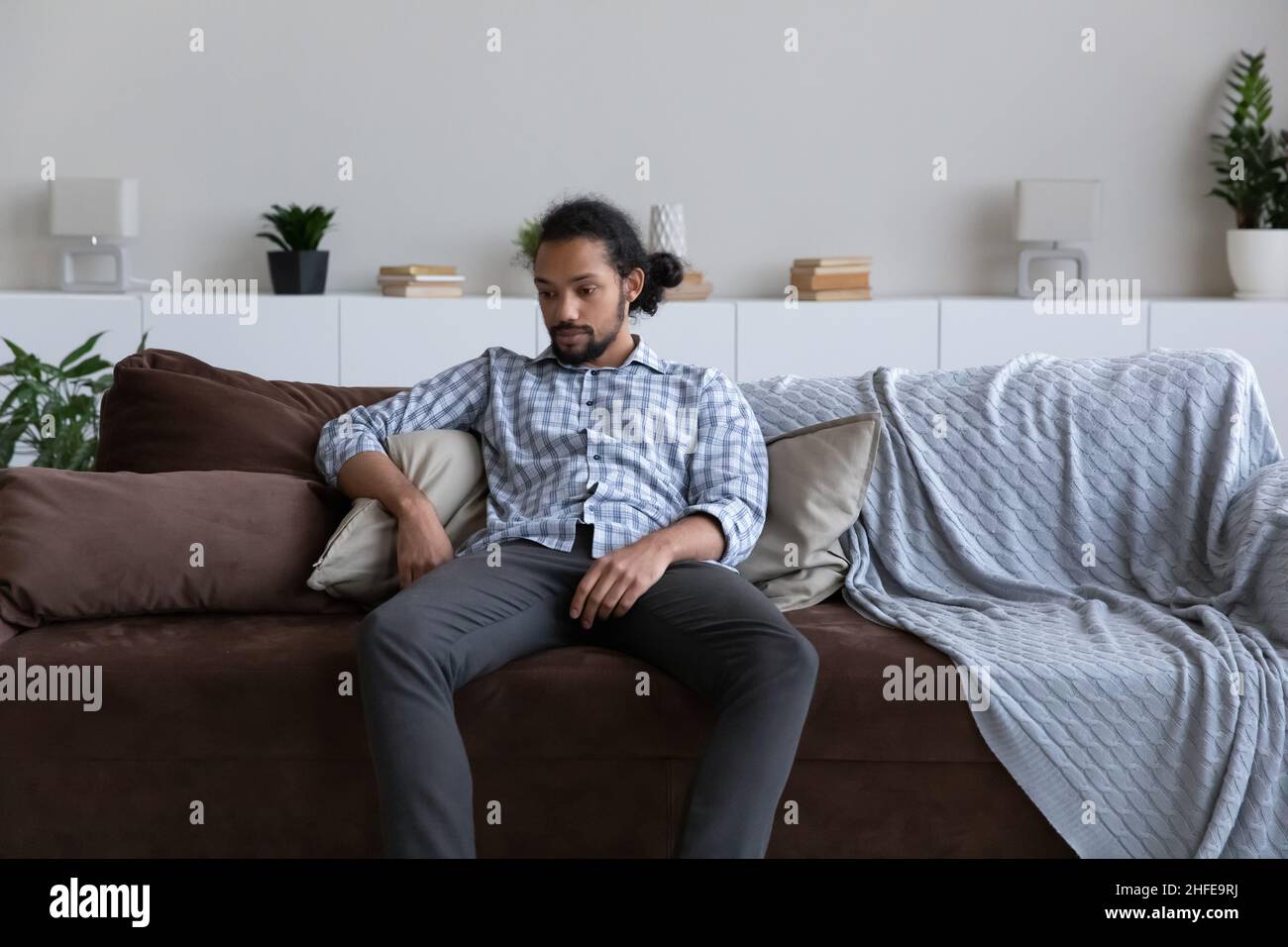 Passive bored sad African guy feeling tired, suffering from apathy Stock Photo