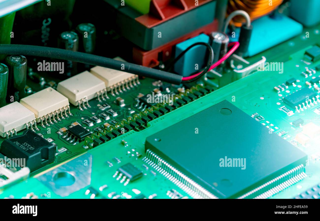 Electronic circuit board. Semiconductor motherboard circuit board technology. Mainboard of computer. Integrated semiconductor microchip on green Stock Photo