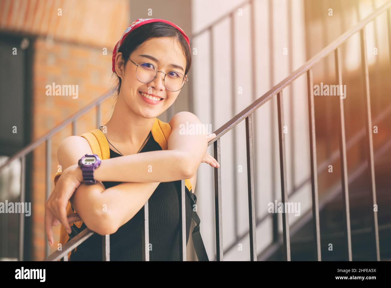 portrait cute university teen girl Thai Asian with glasses happy smile Stock Photo