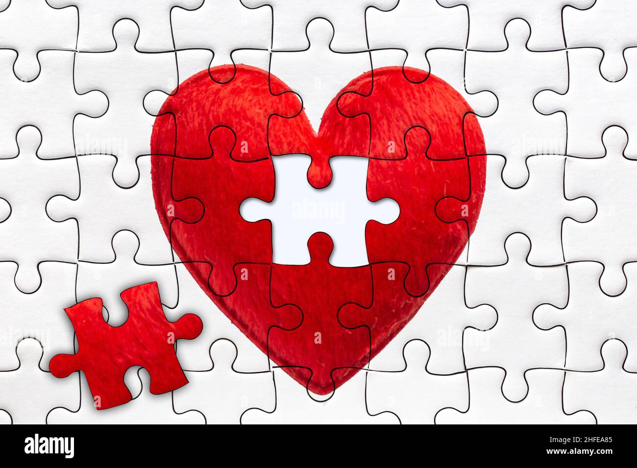 last piece to complete heart jigsaw puzzles for full fill love together concept Stock Photo