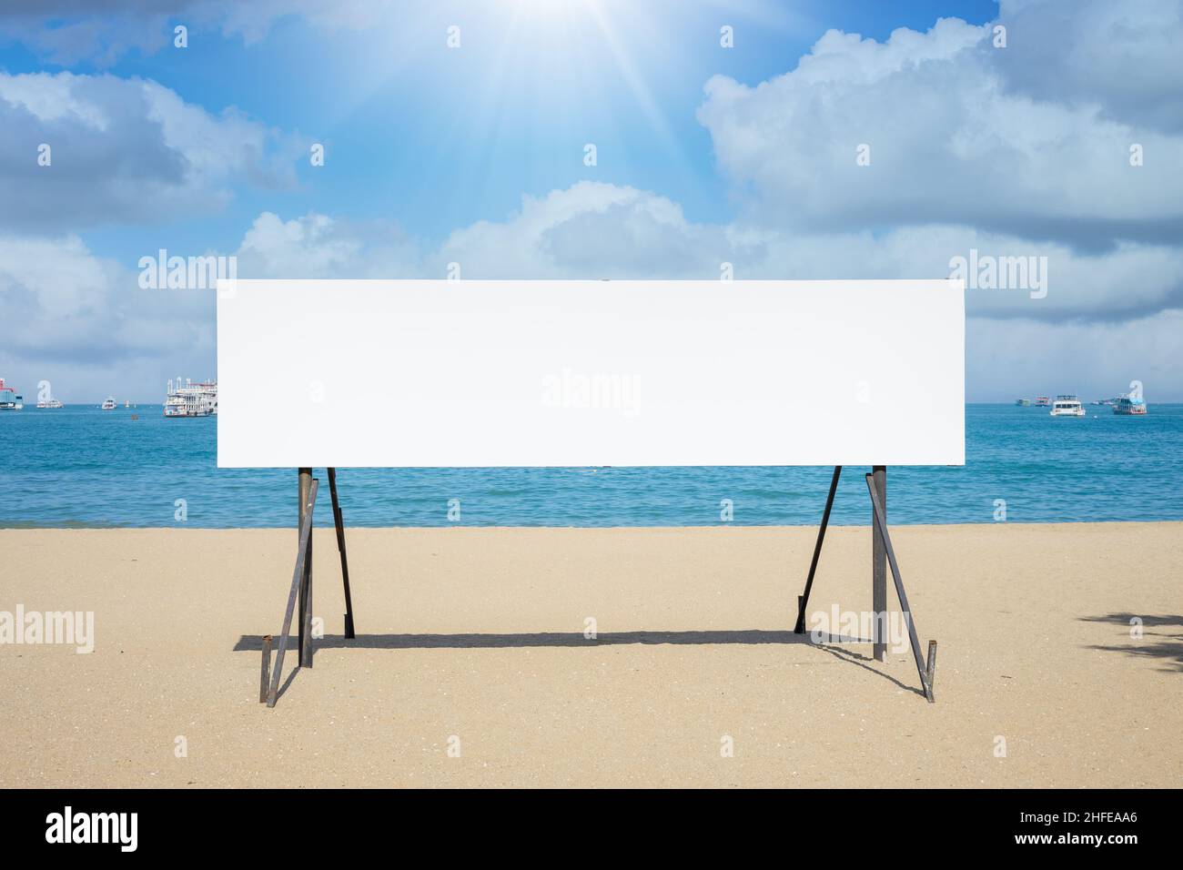 blank advertising announce board on the sea beach with summer ocean background Stock Photo