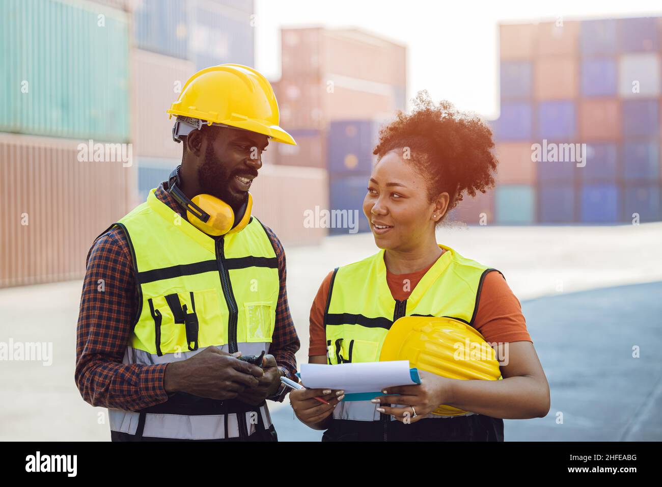African man and women happy working talking together in cargo logistic port Stock Photo