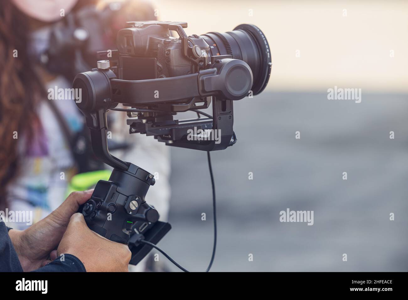 Motorized Gimbal, people using digital camera with anti shake for video production scene stabilizer Stock Photo