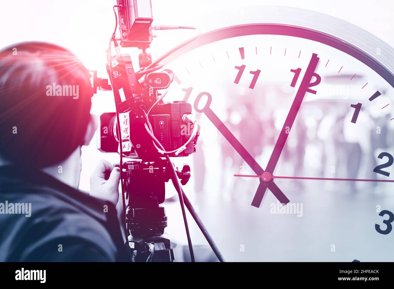 video camera man in media news broadcasting industry working overlay with time clock for work against time concept Stock Photo