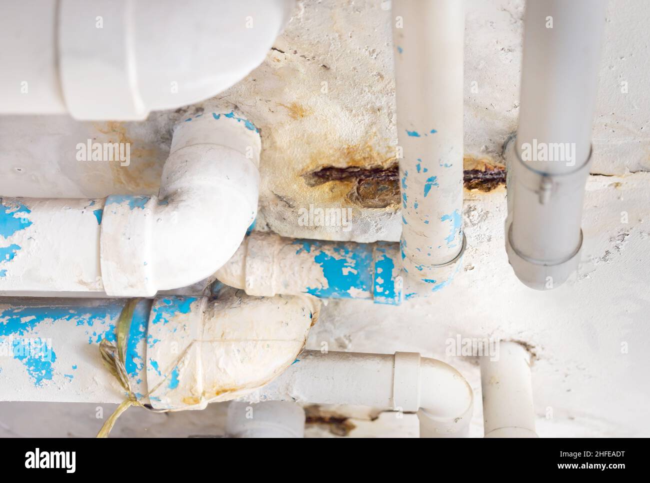 Damaged PVC Water pipe leak , building drainage pipes crack seep problem need to fix Stock Photo