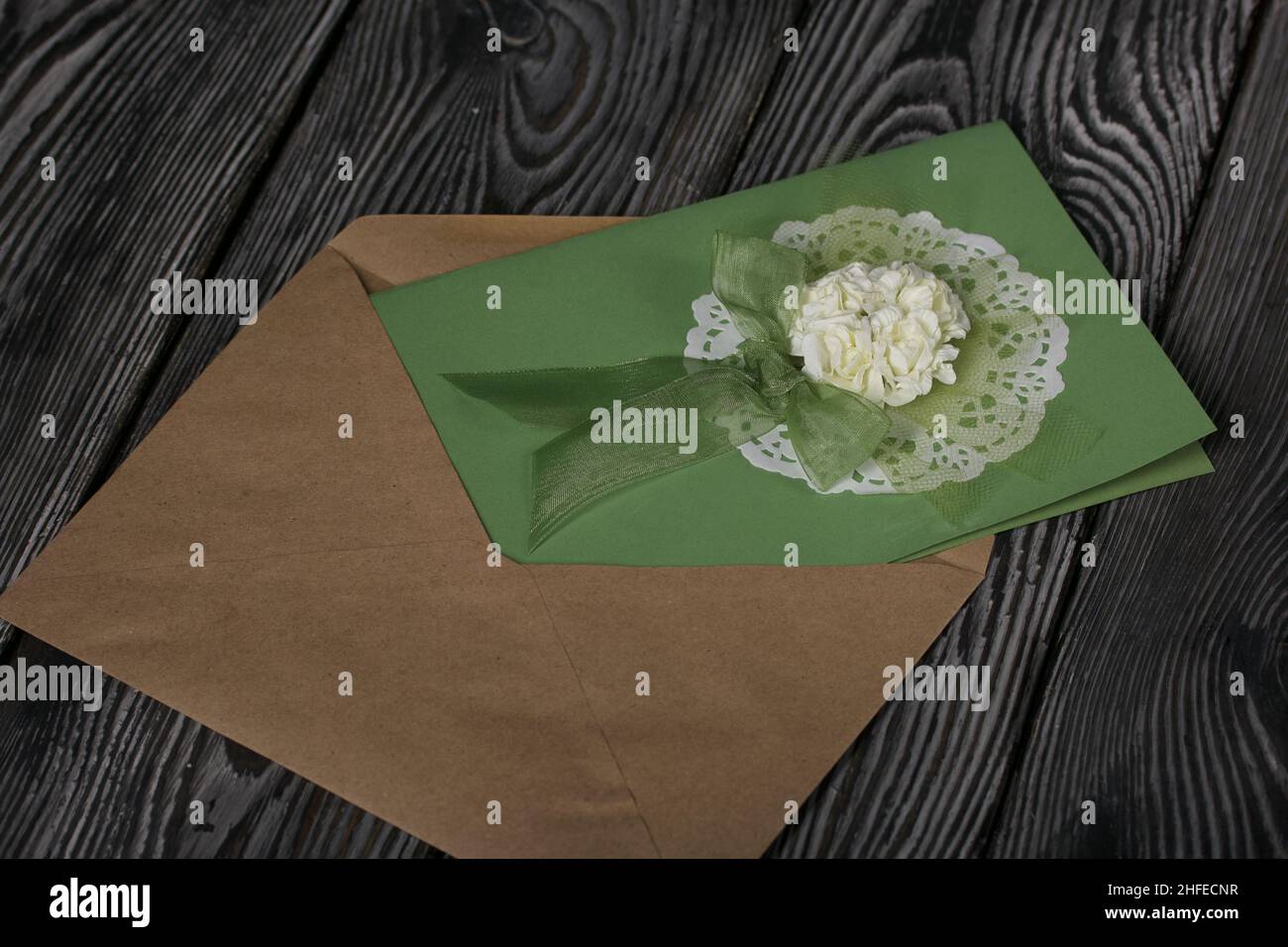 Greeting card in an envelope. On pine boards. Stock Photo